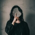 A woman with long hair covering her face