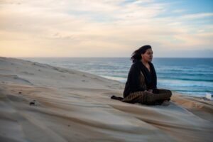 woman seen sitting on sand dune while watching the 2025 01 07 09 49 25 utc